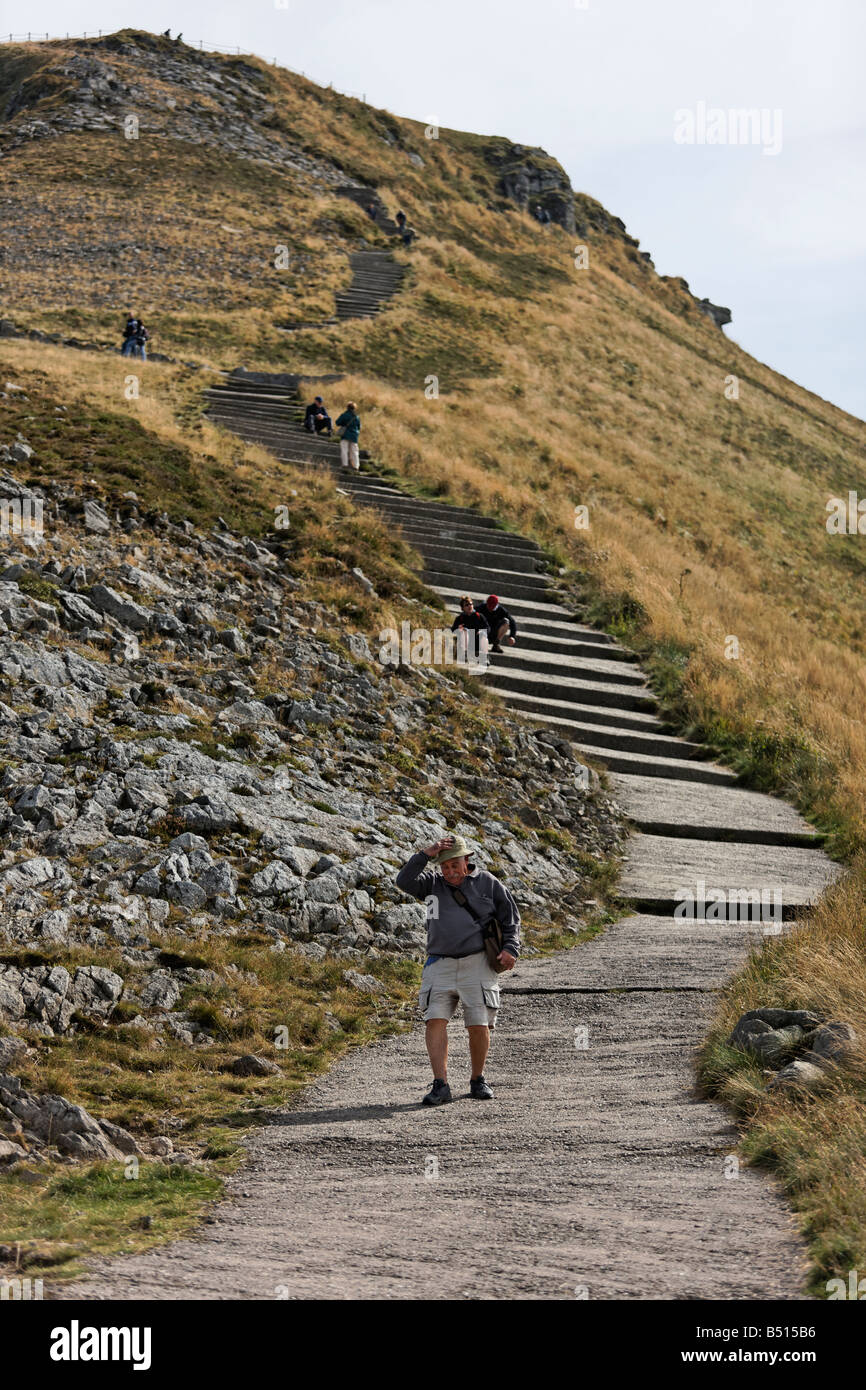 Tourists trek up and down the Puy Mary volcano, France Stock Photo