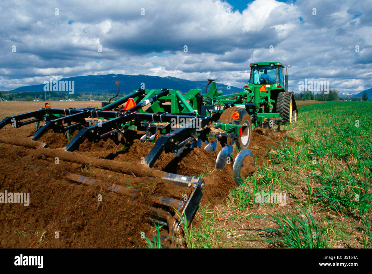Seed bed preparation with a disk ripper prior to planting potatoes in Skagit County, WA Stock Photo
