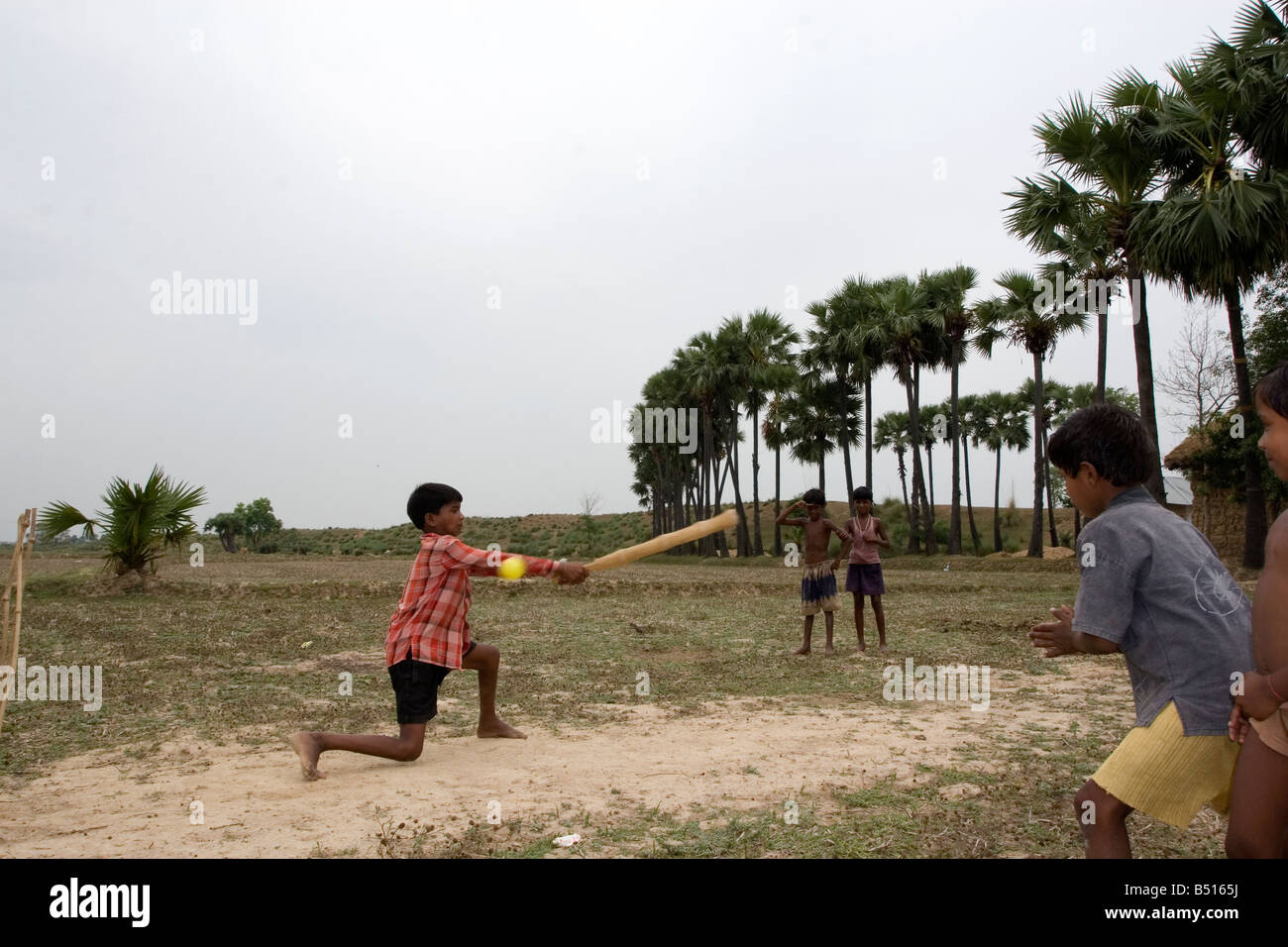 Rural boys enjoy cricket playing in West Bengal,India Stock Photo