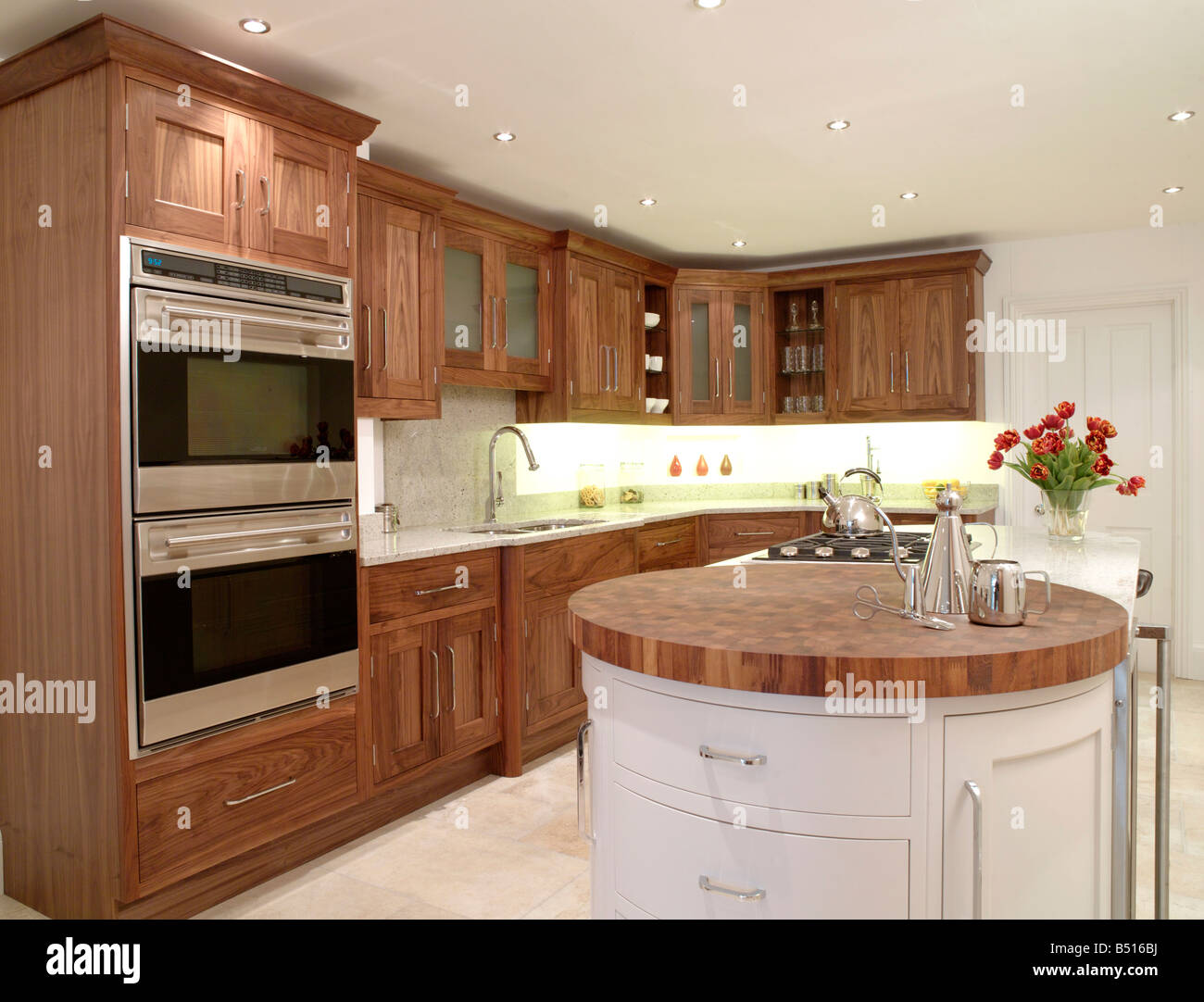 John Ladbury dark wood kitchen with round wood peninsular unit Stock Photo