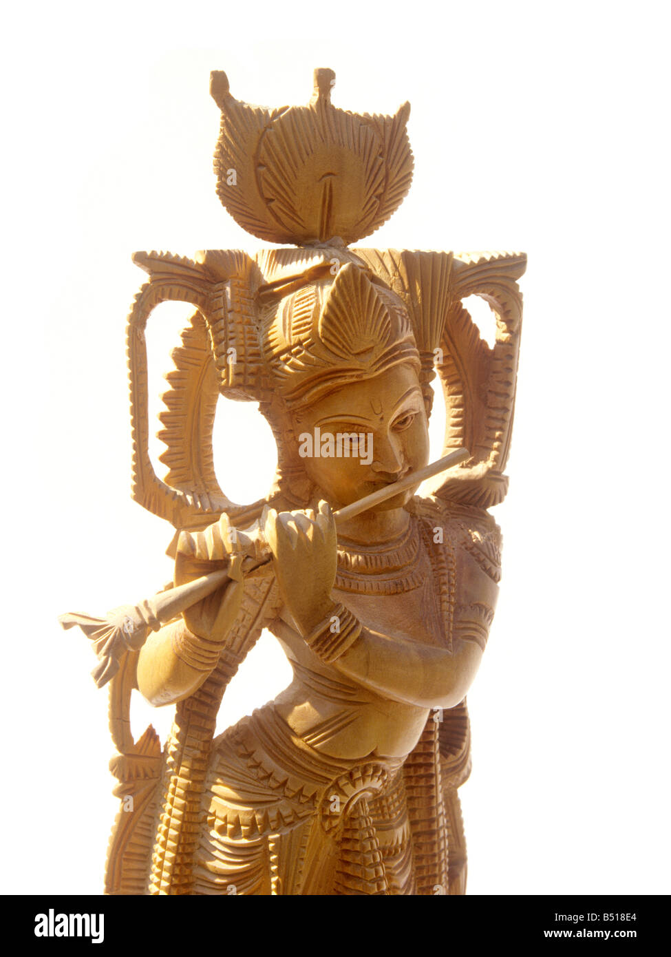 Indian crafts sandalwood carving of Hindu God Krishna playing flute from Mysore Karnataka Stock Photo