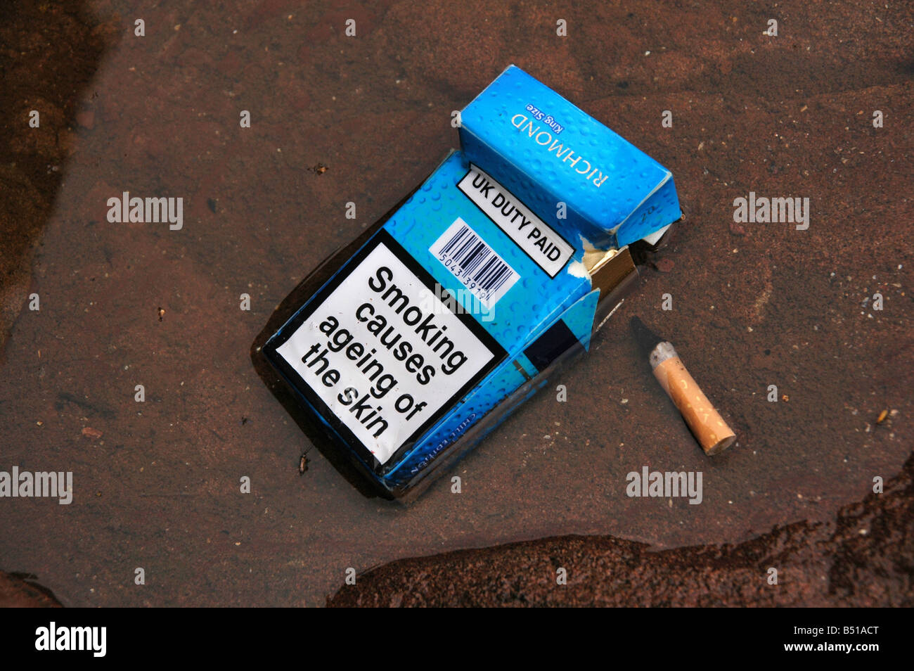 An empty packet of cigarettes with the warning of 'smoking causes