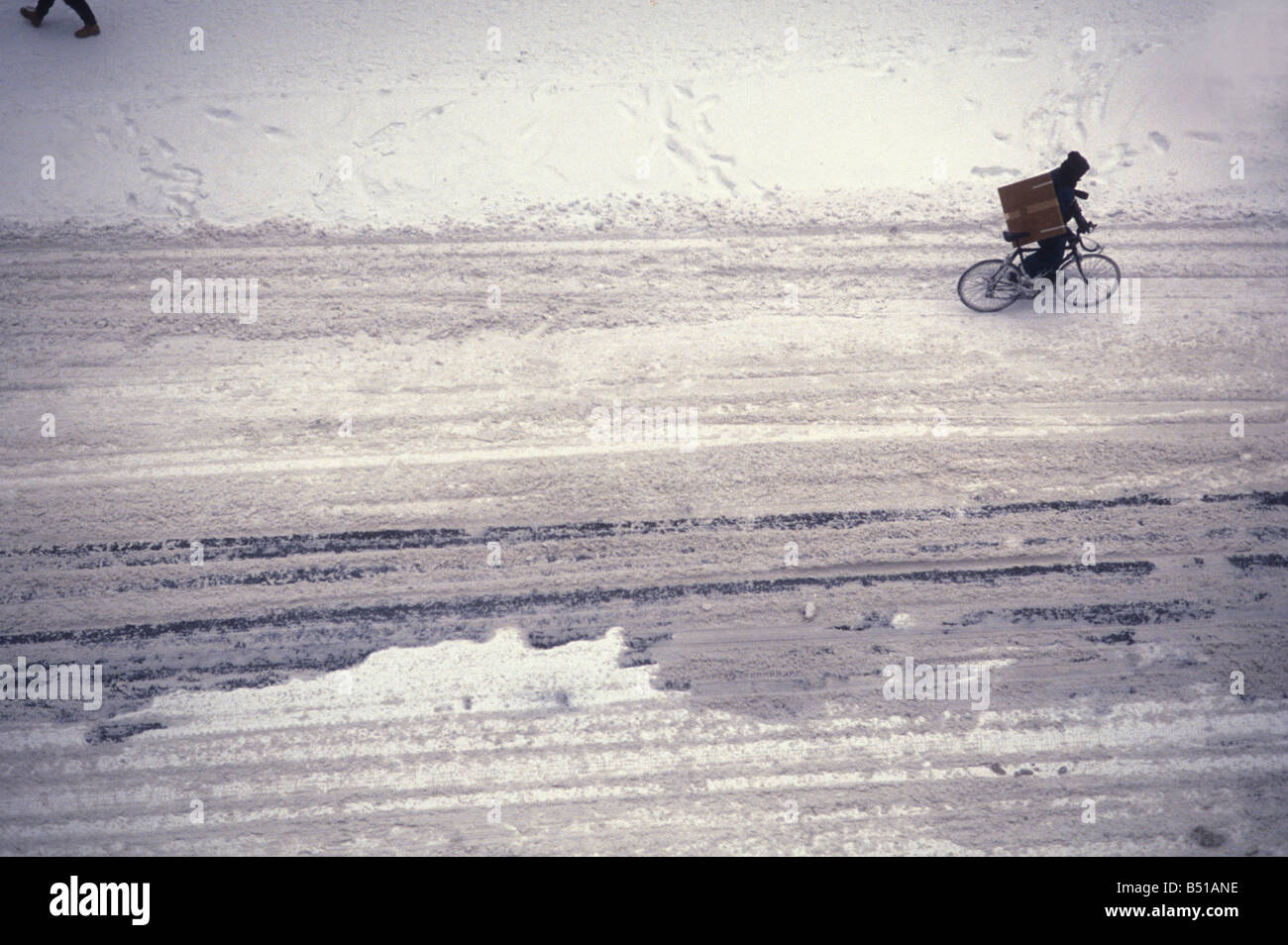 bike messenger in snow Stock Photo
