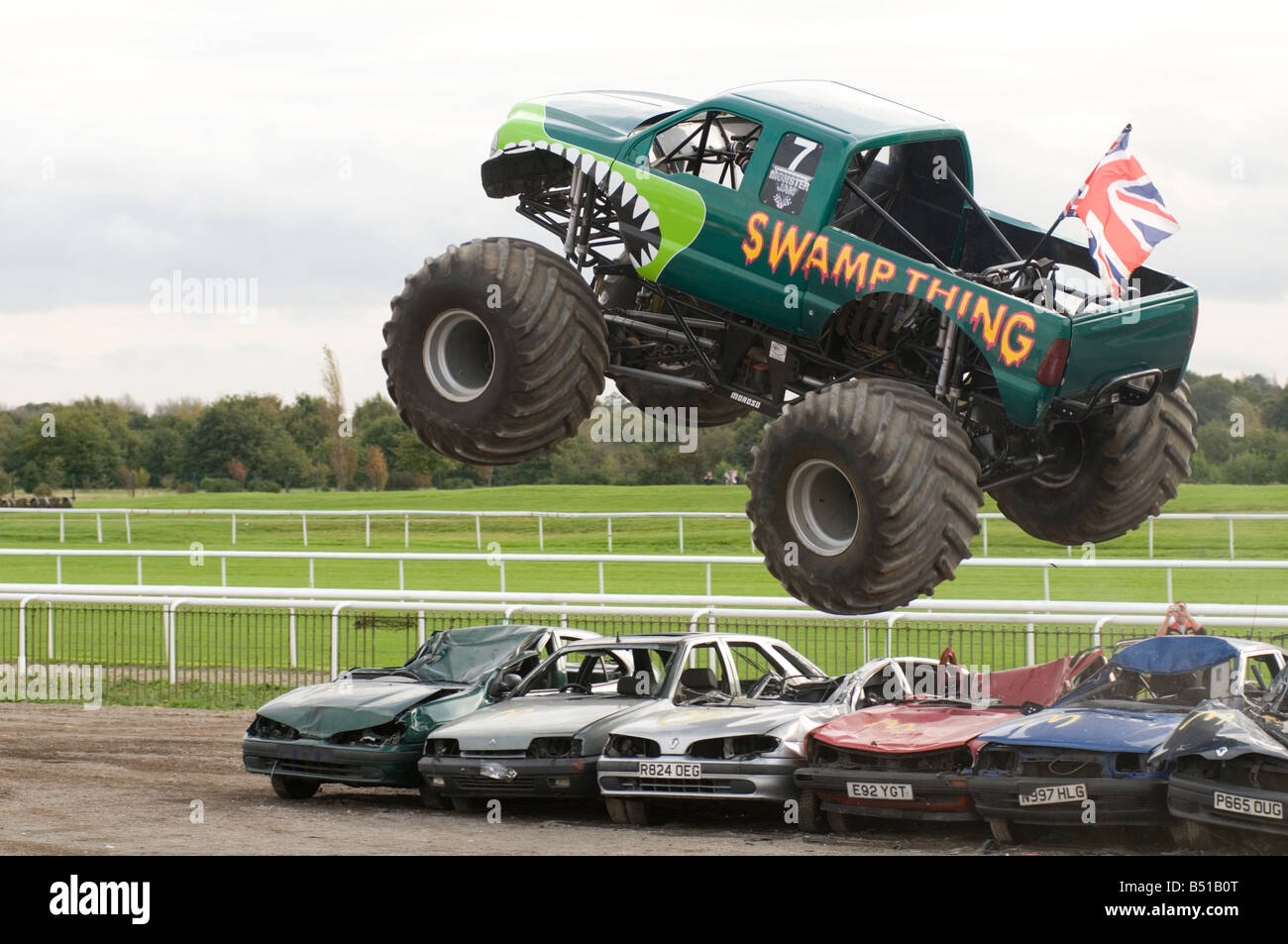 Monster Truck Jumping Over Crushed Cars In A Race Stock Photo Alamy