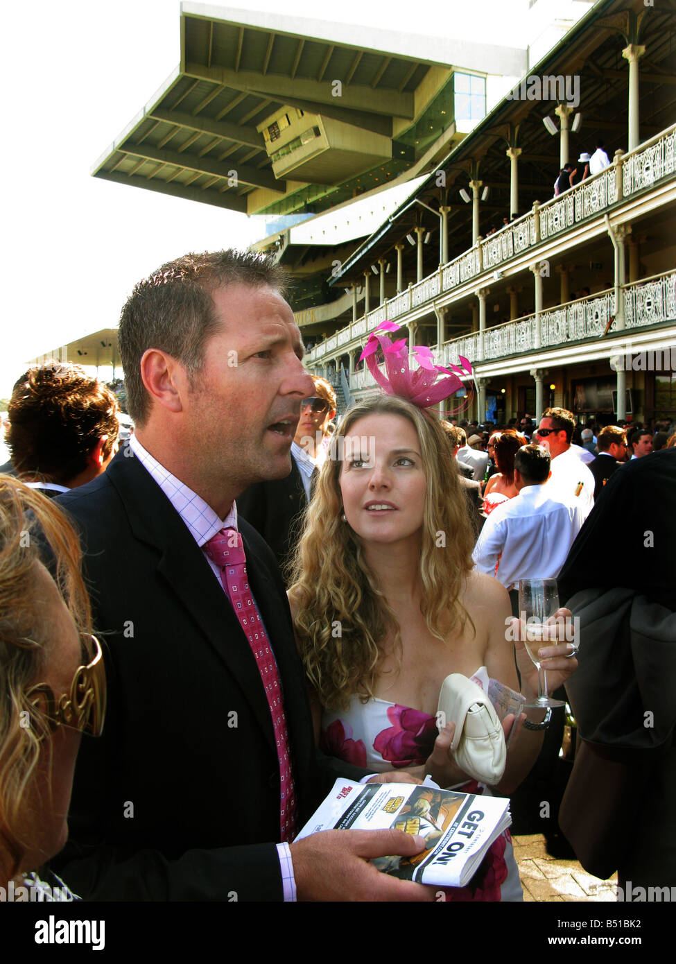 A young couple study the form at Randwick Racecourse Sydney Australia Stock Photo