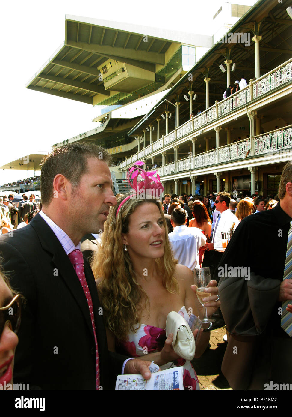 A young couple study the form at Randwick Racecourse Sydney Australia Stock Photo