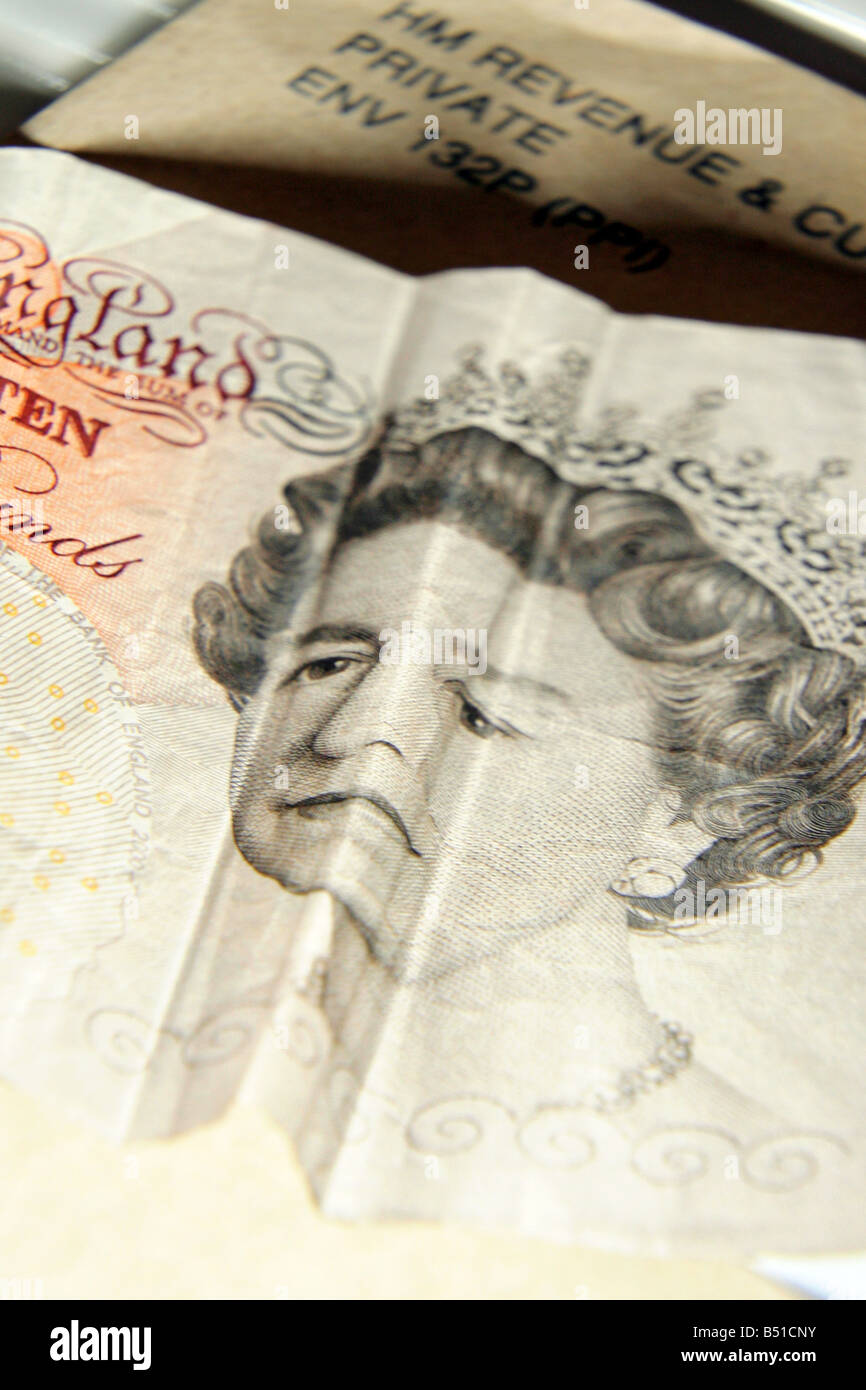 Ten pound note and tax return envolope Stock Photo