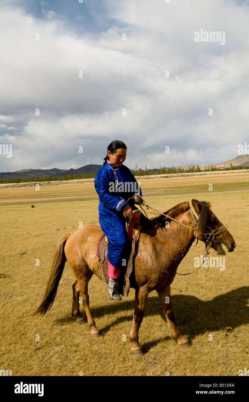 A Mongolian nomad on her horse Stock Photo - Alamy