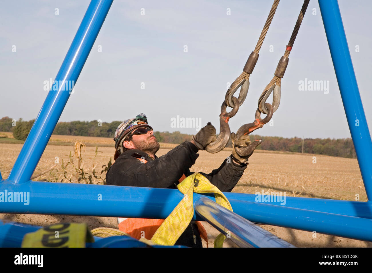 Workers Assemble Crane Used to Lift Blades Onto a Wind Turbine Stock Photo