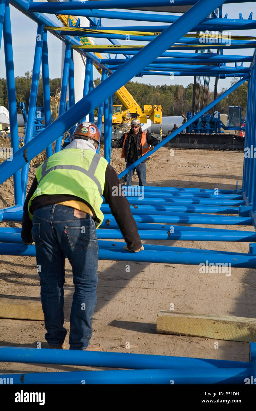 Workers Assemble Crane Used to Lift Blades Onto a Wind Turbine Stock Photo