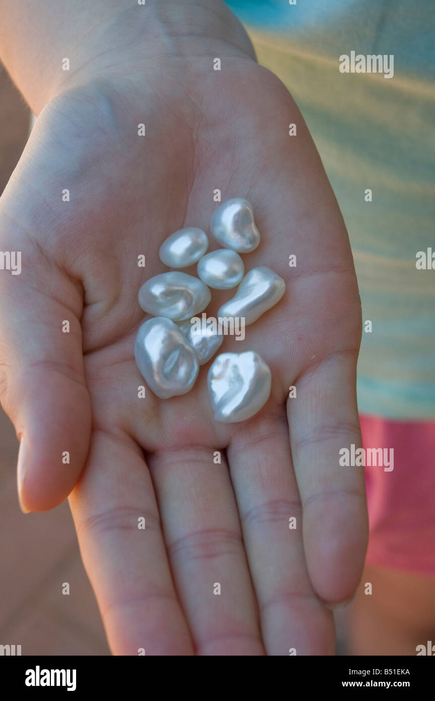 A handful of keshi natural cultivated saltwater pearls of unusual shape produced without seeding from a nucleus Stock Photo