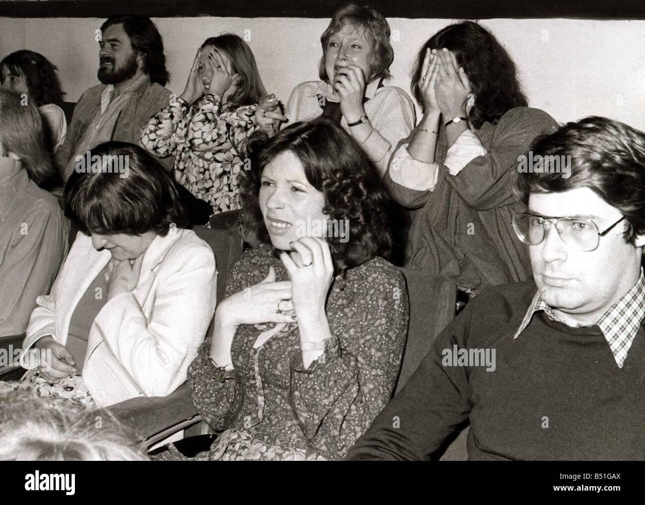 Audiences reaction to original screening of Alien in Odeon Theatre Leicester Square A woman covers her face in fear June 1979 Stock Photo