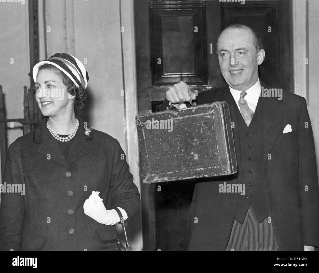 The Chancellor of the Exchequer (George Edward) Peter Thorneycroft is here seen holding up the budget box-when accompanied by his wife, he leaves no II. Downing St. for the house, this afternoon. April 1957 P000213; Stock Photo