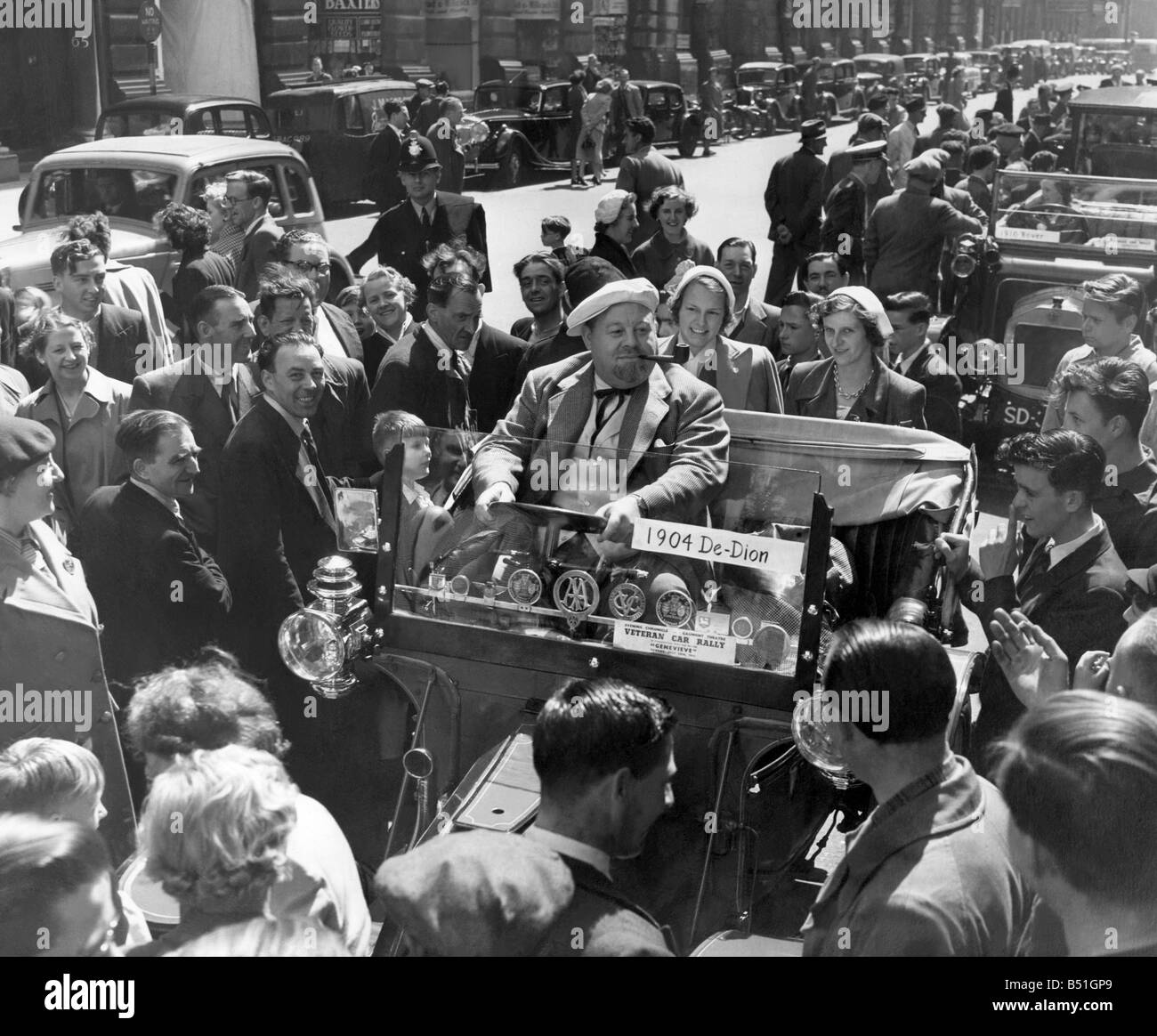 American folk song singer Burl Ives, trys the drivers seat in a 1904 De Dion, one of the entries in the Veteran Car Rally. Pic taken before they left the Gaumont Theatre, Oxford Street, Manchester. July 1953 P000007; Stock Photo