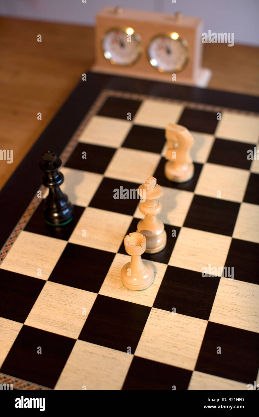 Chessboard with chess figures and chess clock Stock Photo