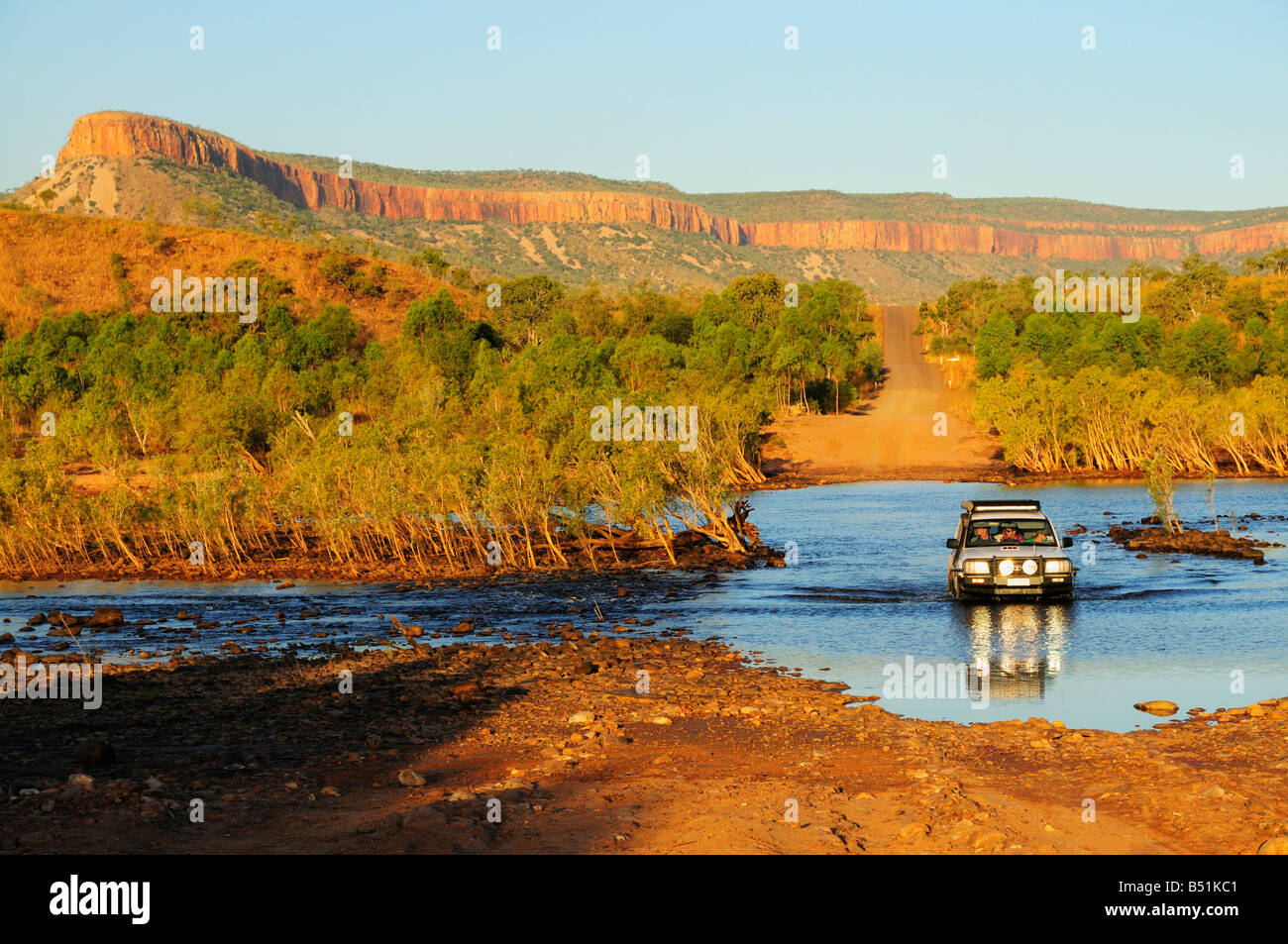 SUV Crossing Pentecost River with Cockburn Ranges in Background, Gibb River Road, Kimberley, Western Australia, Australia Stock Photo