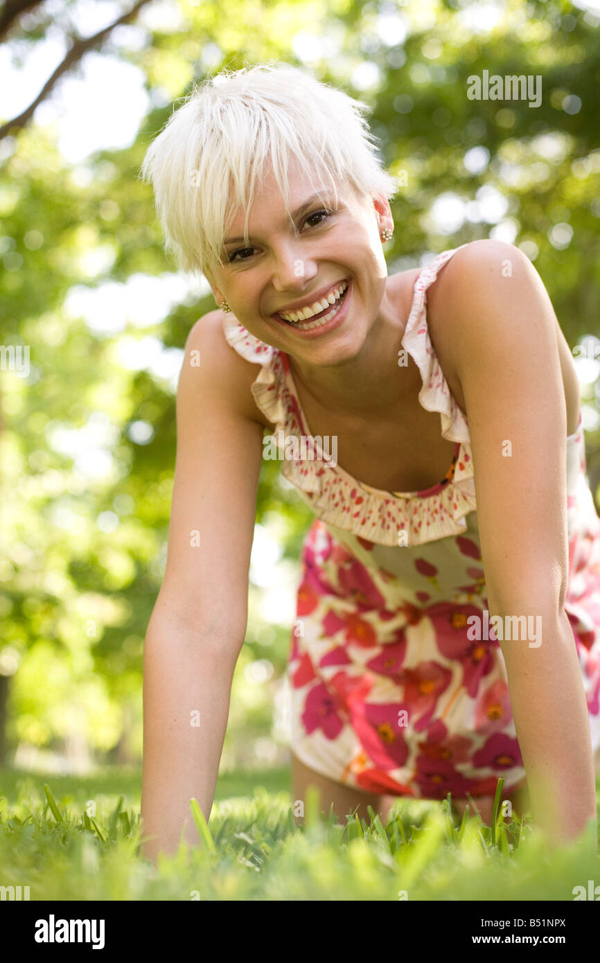 Portrait of Woman on Hands and Knees Outdoors Stock Photo
