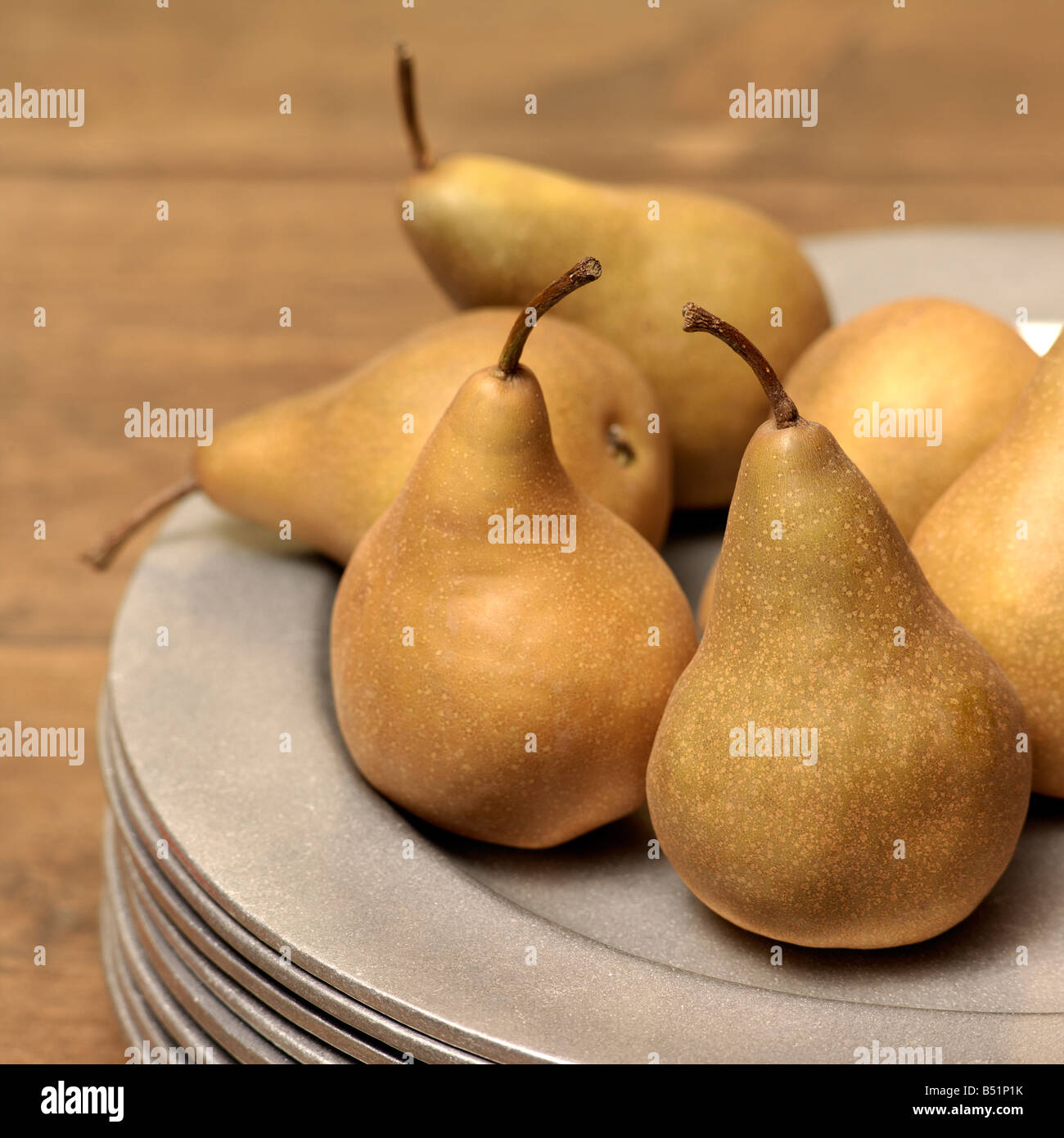 Bosc Pears on Stack of Plates Stock Photo Alamy