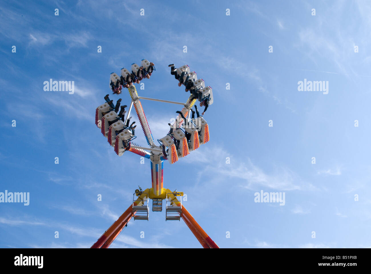 High speed thrilling carnival ride on brilliant blue sky background
