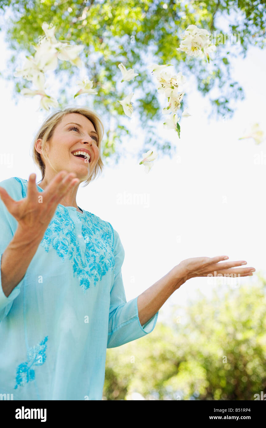 Woman Throwing Flowers into Air Stock Photo Alamy