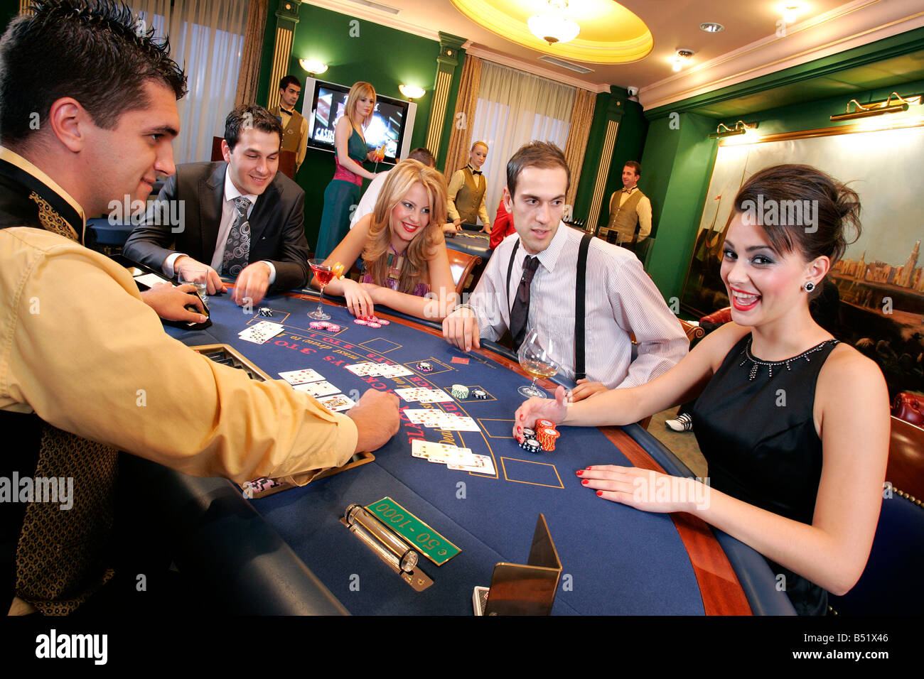 Blackjack Live casino happy gamblers back jack punters punter gaming plaything pledge addiction easy money dollar pound bet bett Stock Photo
