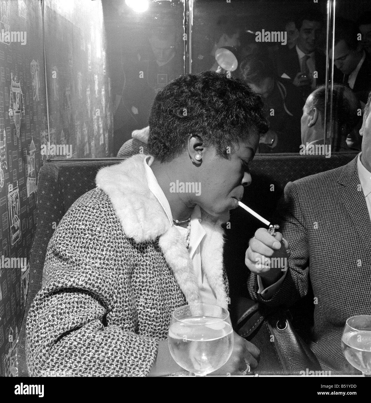 Sarah Vaughan at the Satire Club London lighting up a cigarette Stock Photo