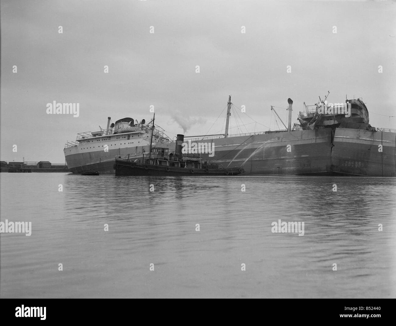 The oil tanker Atlantic Duchess explodes while in Swansea Docks. Feb. 1951;Five bodies are recovered from wreckage of the empty Stock Photo