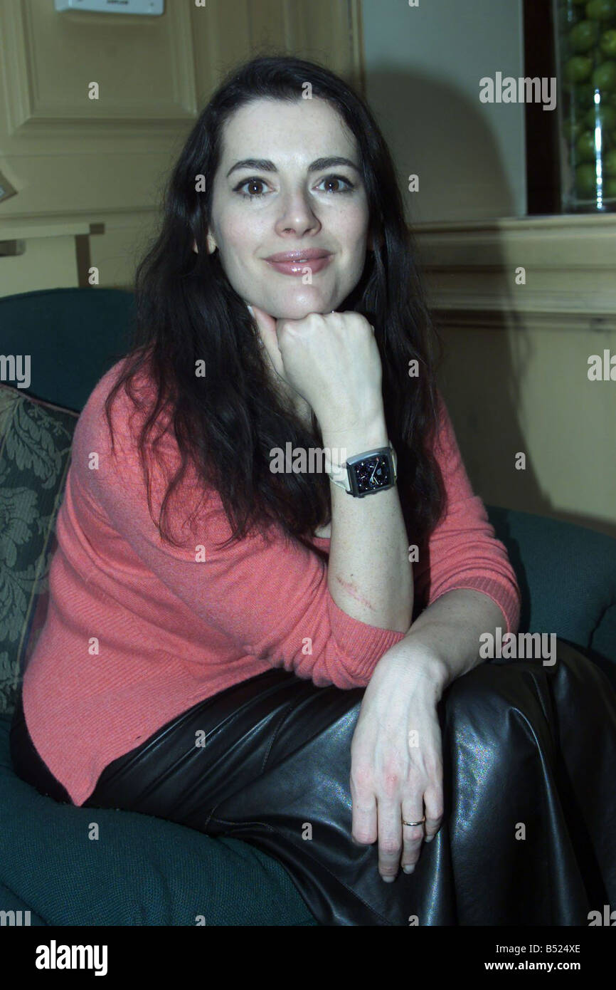 Nigella Lawson relaxing on blue sofa Dec 2000 during interview with Nina Miskow Stock Photo