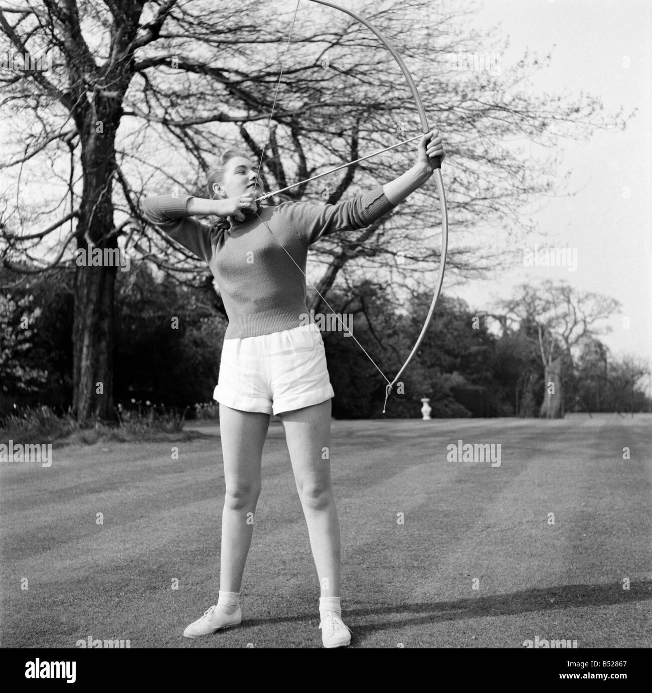 Taking part in the documentary film 'Archery' which is being made by Faro Films, London, is pretty Miss Sylvia Chapman, 18, from Kingsbury. Seen filming in Richmond park. April 1953 D2093 Stock Photo