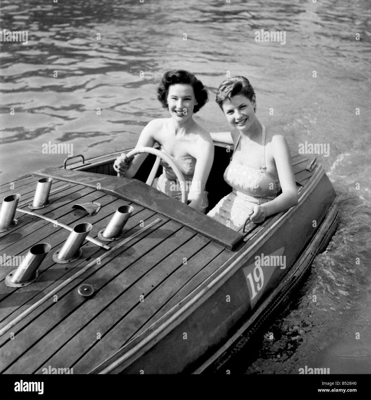 Holiday Two young women enjoying the boating pool at the Festival pleasure gardens, London. June 1953 D3355 Stock Photo