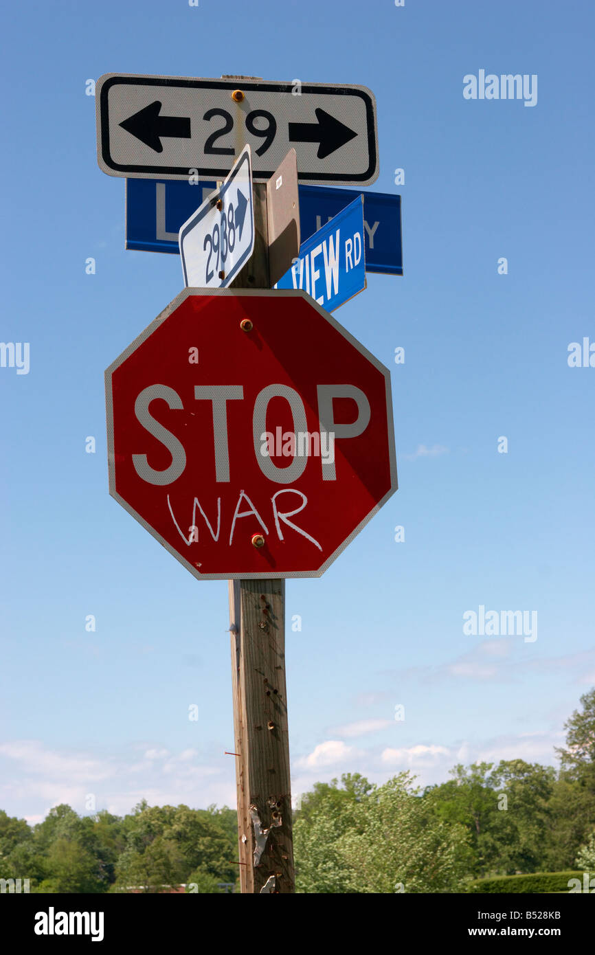 A suburban Stop sign with anti war graffiti Stock Photo