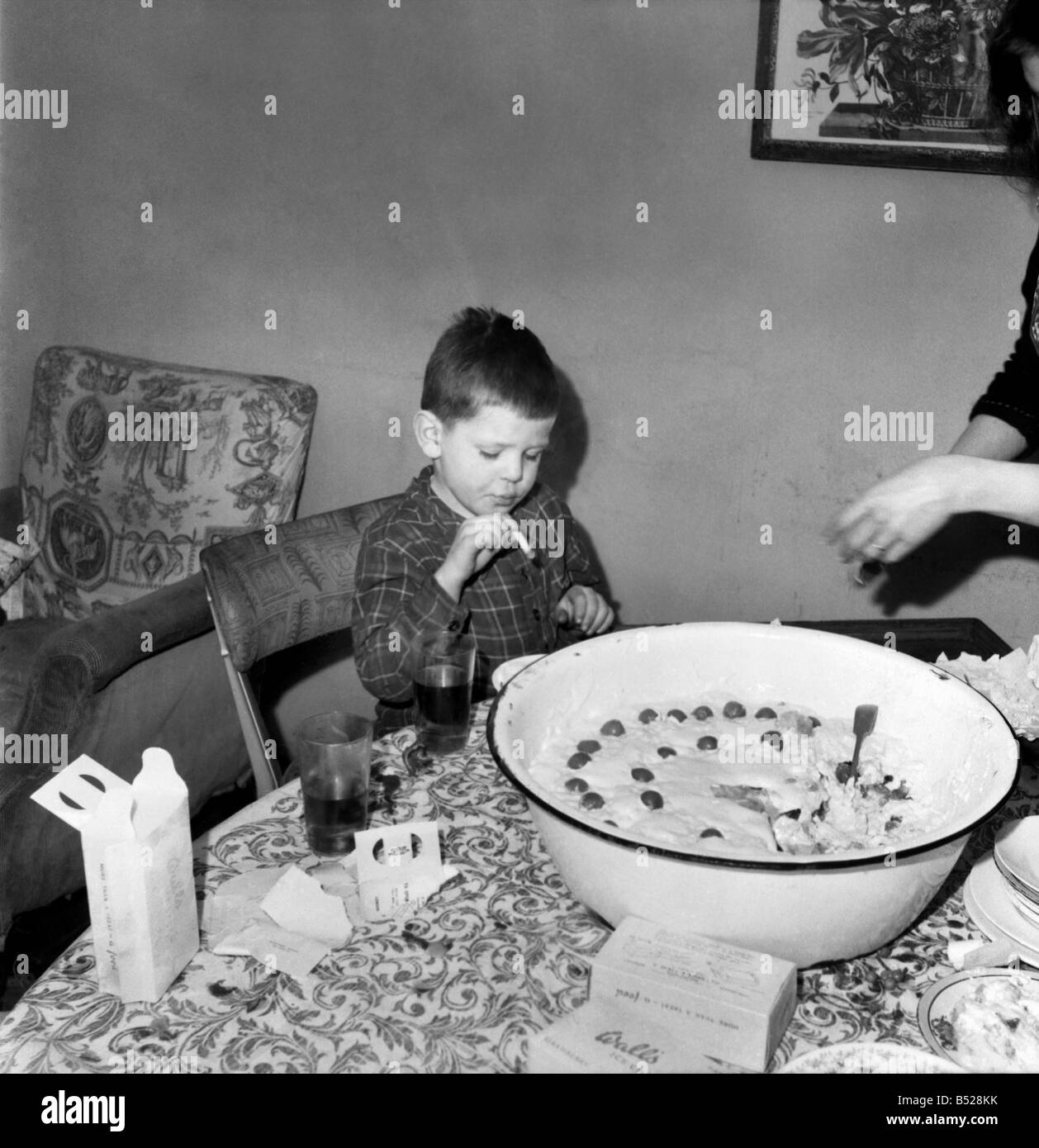 Childrens Party given by M. R. Copping. ;Young boy smoking a cigarette as  he sits at the dinner table;January 1953 ;D514-004 Stock Photo