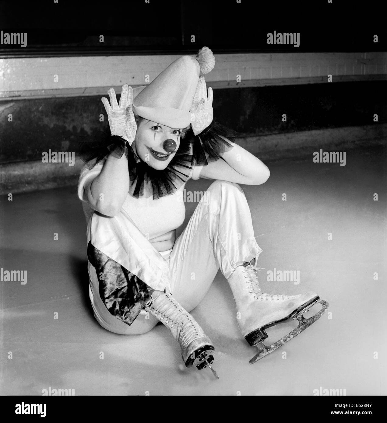 An Ice Skating female Clown performing . &#13;&#10;January 1953 D597-002 Stock Photo