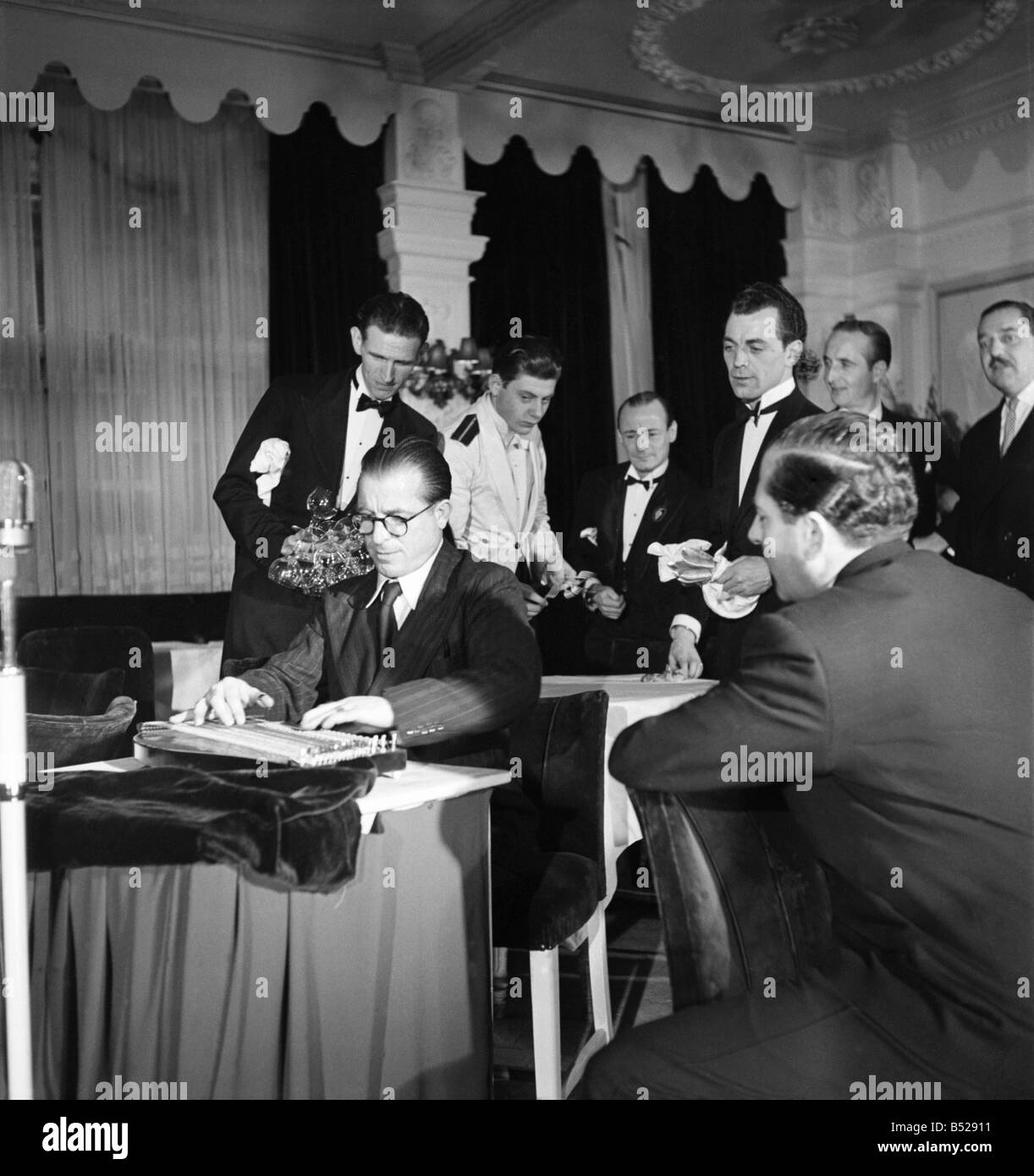 Anton Karas playing the zither at London's Empress Club. Zither played the theme music to the film The Third Man using the instrument. November 1949 ;O20968 Stock Photo