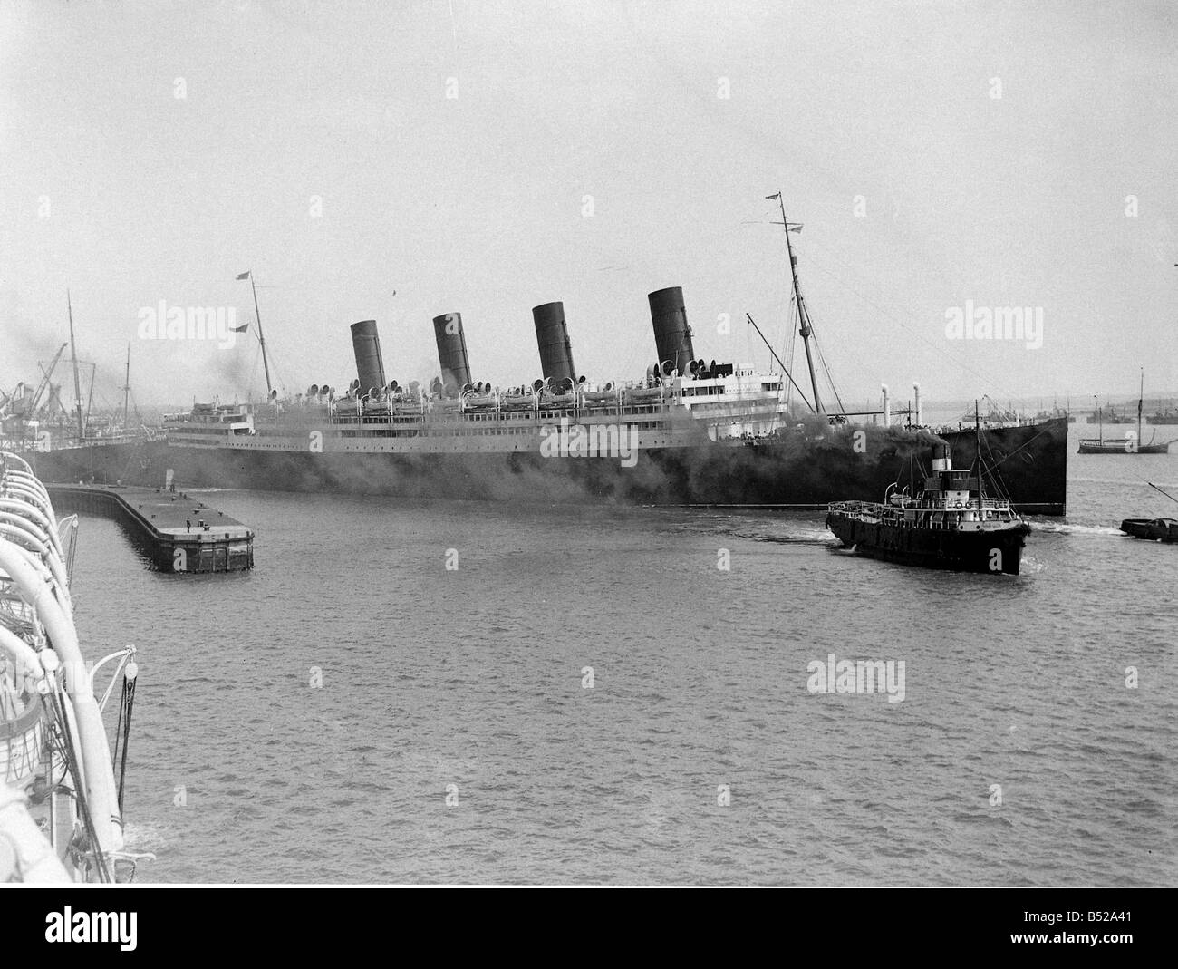 RMS Aquitania seen here leaving Southampton with a crew of volunteer stewards The Aquitania was built by John Brown Co Glasgow in 1913 for the Cunard Steamship Co She was a 45 647 gross ton ship overall length 901 5ft x beam 97ft 274 77m x 29 56m four funnels two masts four screws and a speed of 23 knots She carried 597 1st 614 2nd and 2 052 3rd class passengers Launched on 21st April 1913 she started her maiden voyage between Liverpool and New York on 30th May 1914 Her third and last voyage before the Great War started on 11th July 1914 and she was then fitted out as an Armed Merchant Stock Photo