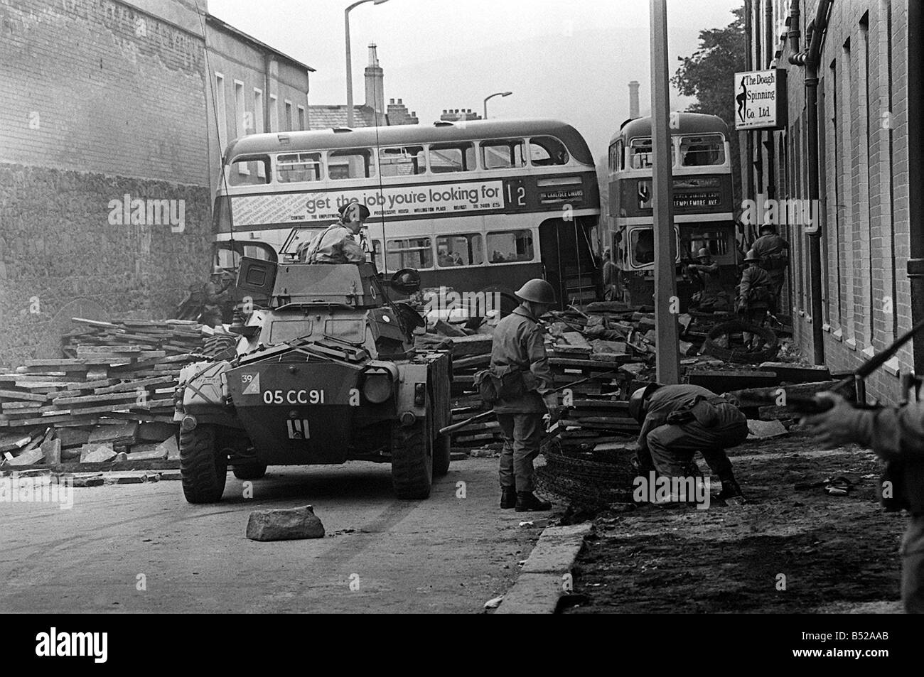 Bus form part of a barricade across a street in the Crumklin Road in Belfast Get the job you re looking for reads the advertisement on the bus There cannot have been many worse jobs than to have been a British soldier on the streets of Northern Ireland during the troubles These troops were erecting a barricade between the two warring sides along a street just off the Crumklin Road Something of a symbolic task The real barricade between the two sides in 1969 were the troops themselves Y2K Ireland Bus form part of a barricade across a street in the Crumklin Road in Belfast Get the job you re looking for reads the advertisement on the bus There cannot have been many worse jobs than to have been a British soldier on the streets of Northern Ireland during the troubles These troops were erecting a barricade between the two warring sides along a street just off the Crumklin Road Something of a symbolic task The real barricade between the two sides in 1969 were the troops themselves Y2K Ireland