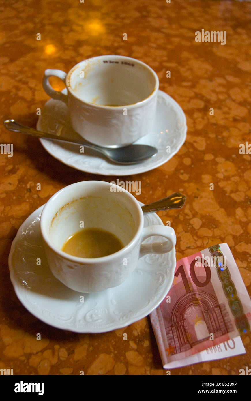 Empty coffee cups and a ten euro note in Cafe Central in Vienna Austria Europe Stock Photo