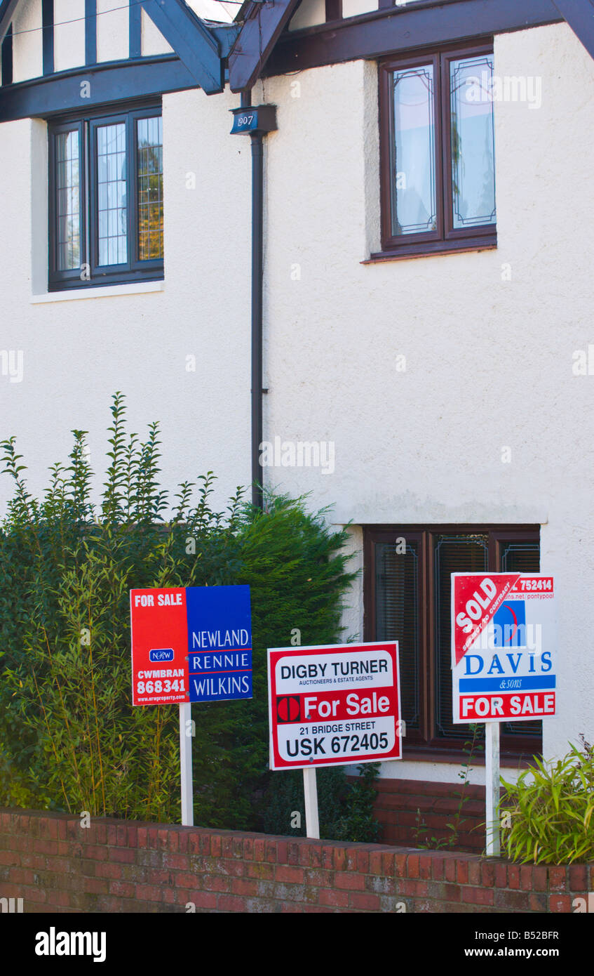 Estate agent for sale boards on semi detached house UK GB Stock Photo