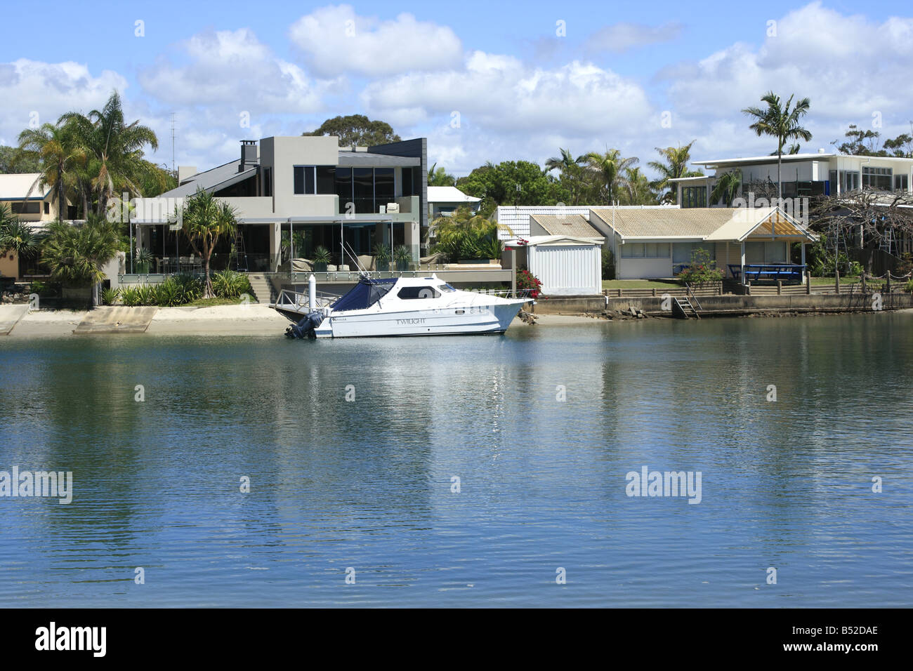 Boat moored outside a private waterfront home in Noosa Heads Qld Australia Stock Photo