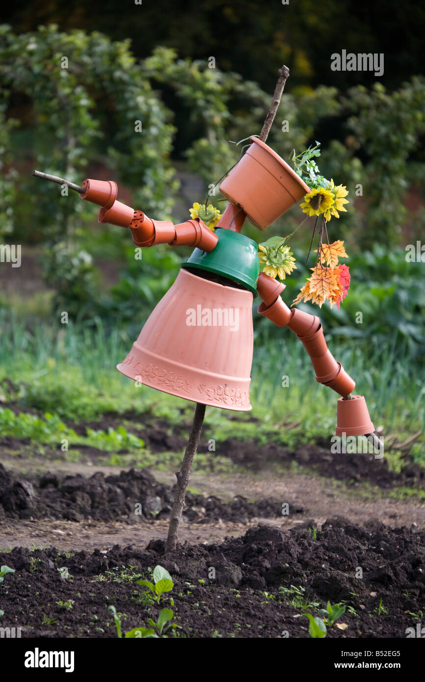 Scarecrow made of old plastic plant pots Stock Photo - Alamy