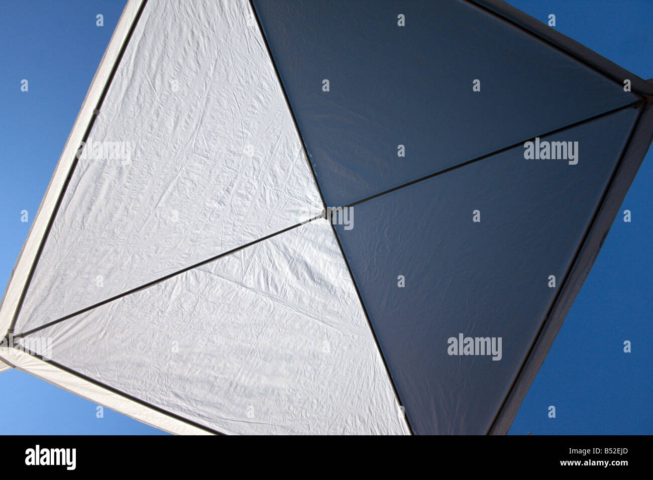 Underside of cheap garden gazebo against blue sky Stock Photo - Alamy