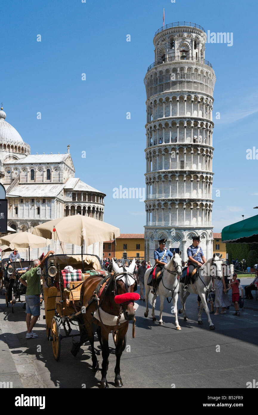 Horse drawn carriage and mounted police in front of the Duomo and Leaning Tower, Campo dei Miracoli, Pisa, Tuscany, Italy Stock Photo