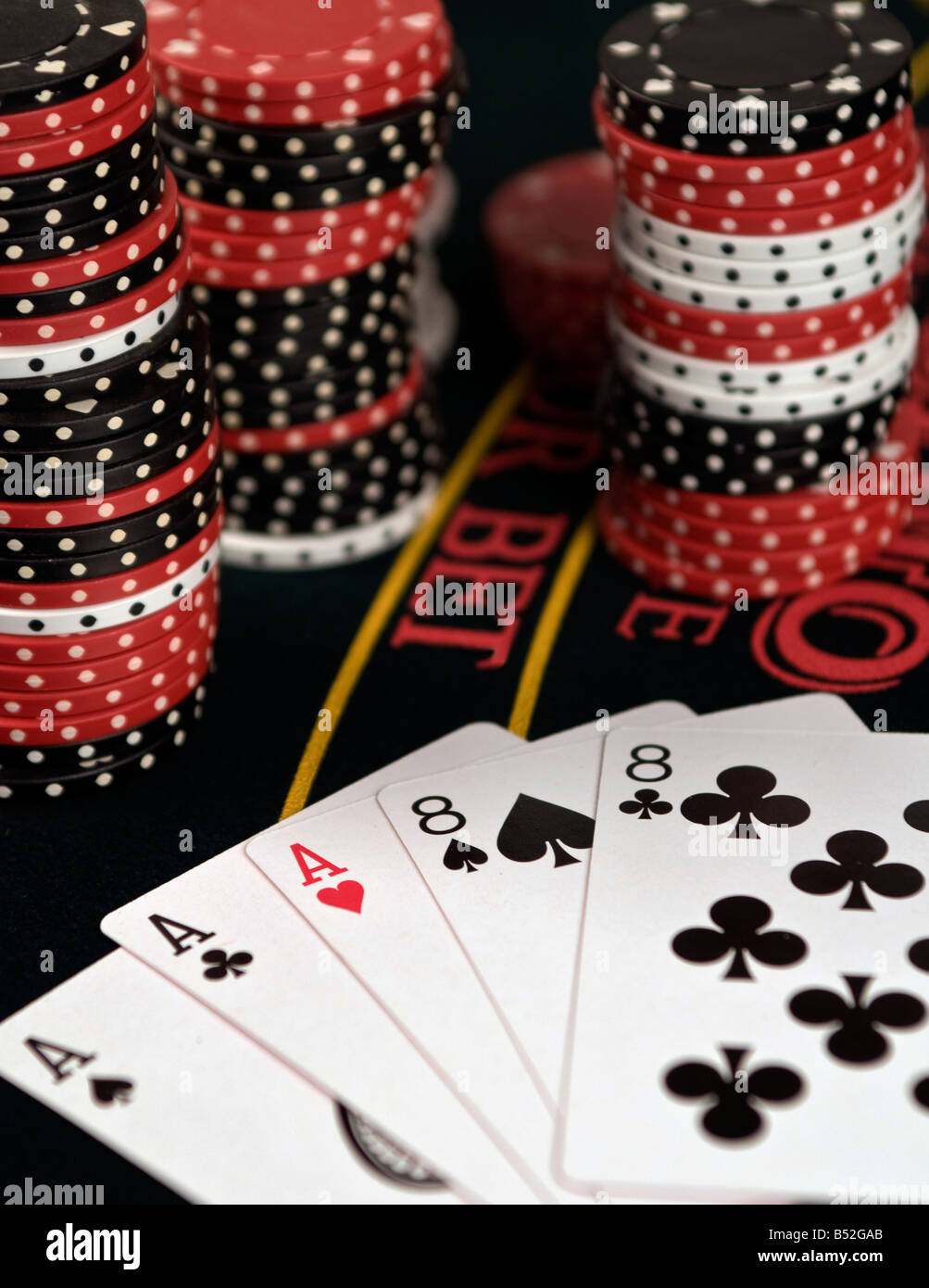 A still life of a winning poker hand, aces and eights. Stock Photo
