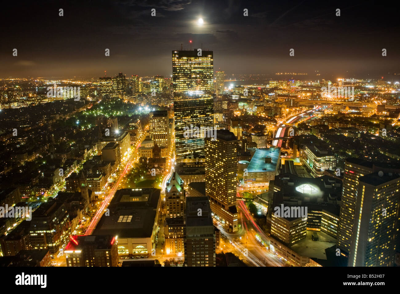 Boston Massachusetts skyline dusk full moon rising over John Hancock Tower Stock Photo