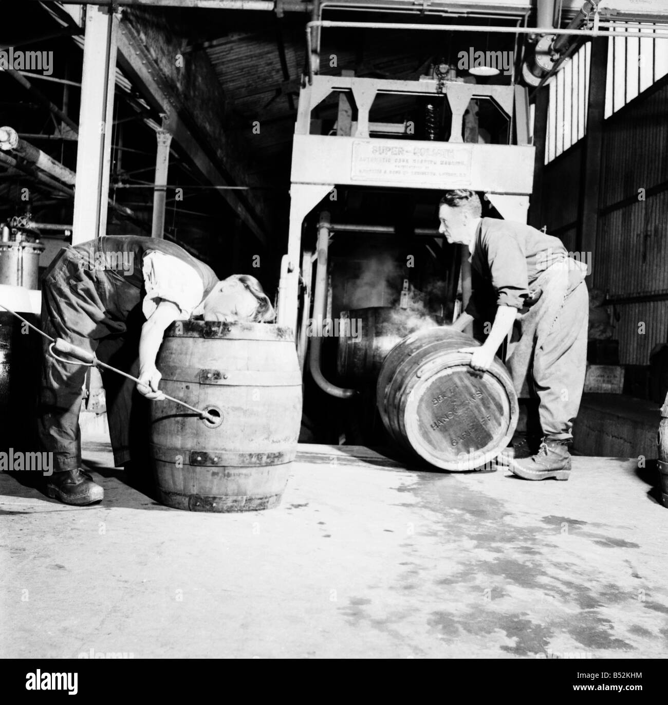 A barrel inspector at work at Hancock's Brewery in Cardiff. July 1952 C3603-003 Stock Photo