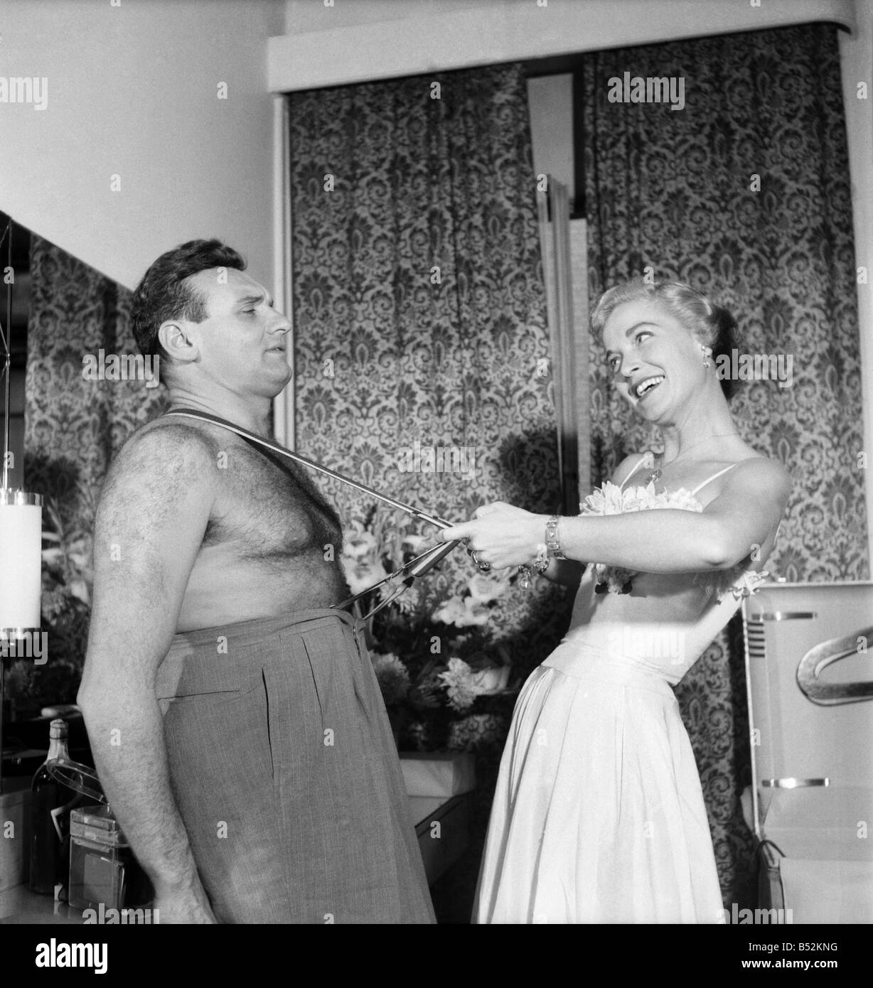 Singer Frankie Laine  with wife, Nan Grey seen here pulling on his braces. August 1952 C4049-001 Stock Photo
