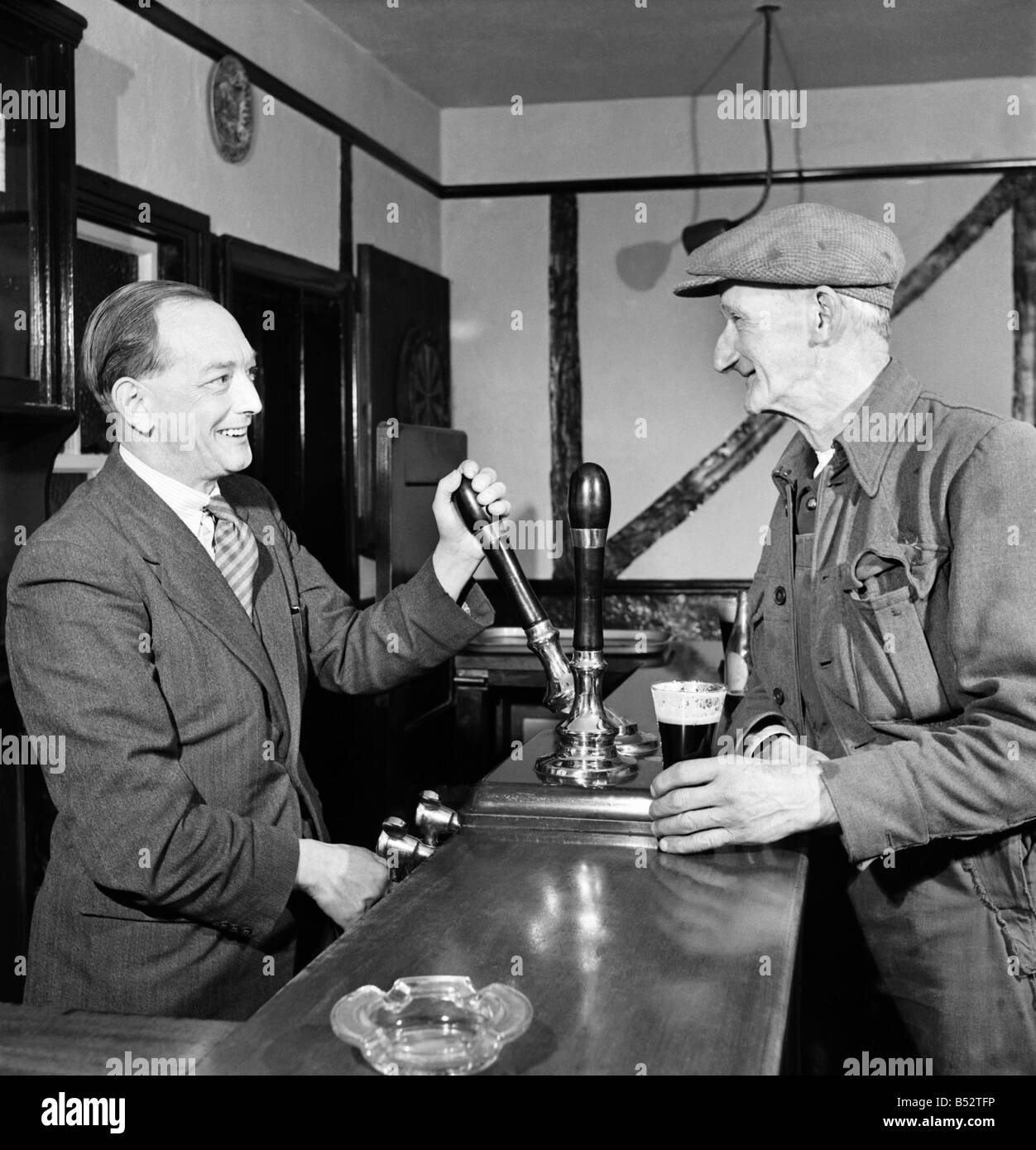 Barman Pours A Pint For A Regular Customer At A Public House October 