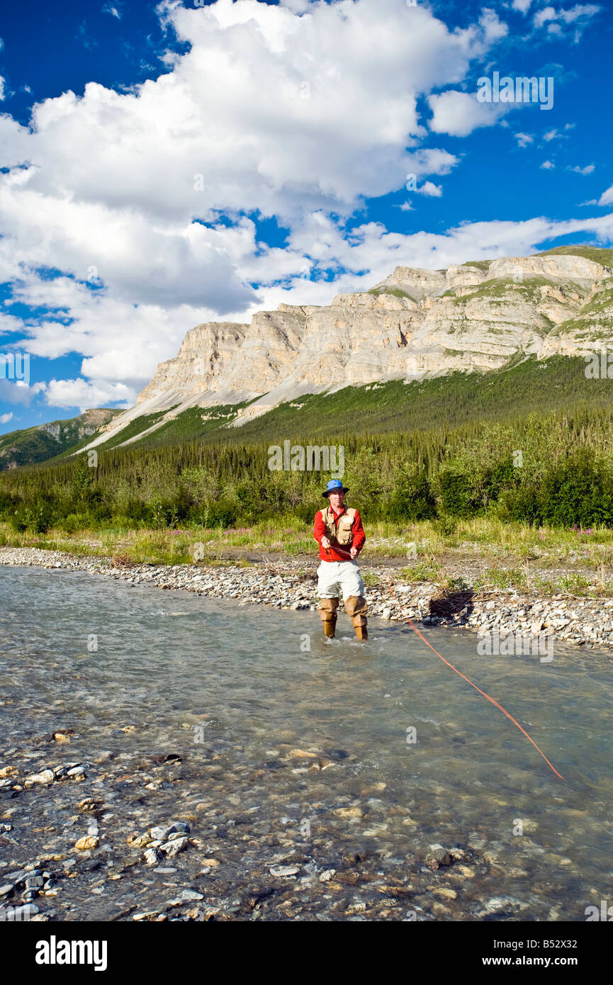 Man fly fishing on the Dietrich River in the Brooks Range during Summer in Alaska Stock Photo