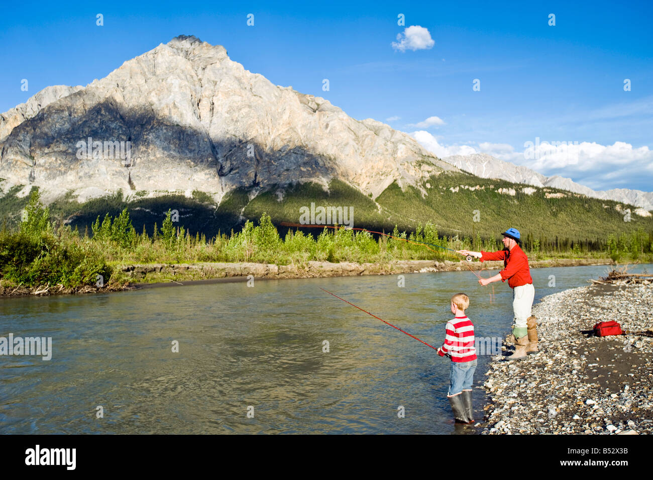 Father and son fishing on the Koyukuk River in the Brooks Range during Summer in Alaska Stock Photo