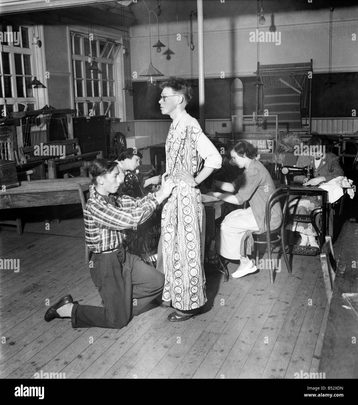 Harry Ogle (16) - Dress Designer seen here fitting his design on another student. There was a lack of female models so Harry used a boy friend to fit the dress. June 1952 C3179 Stock Photo